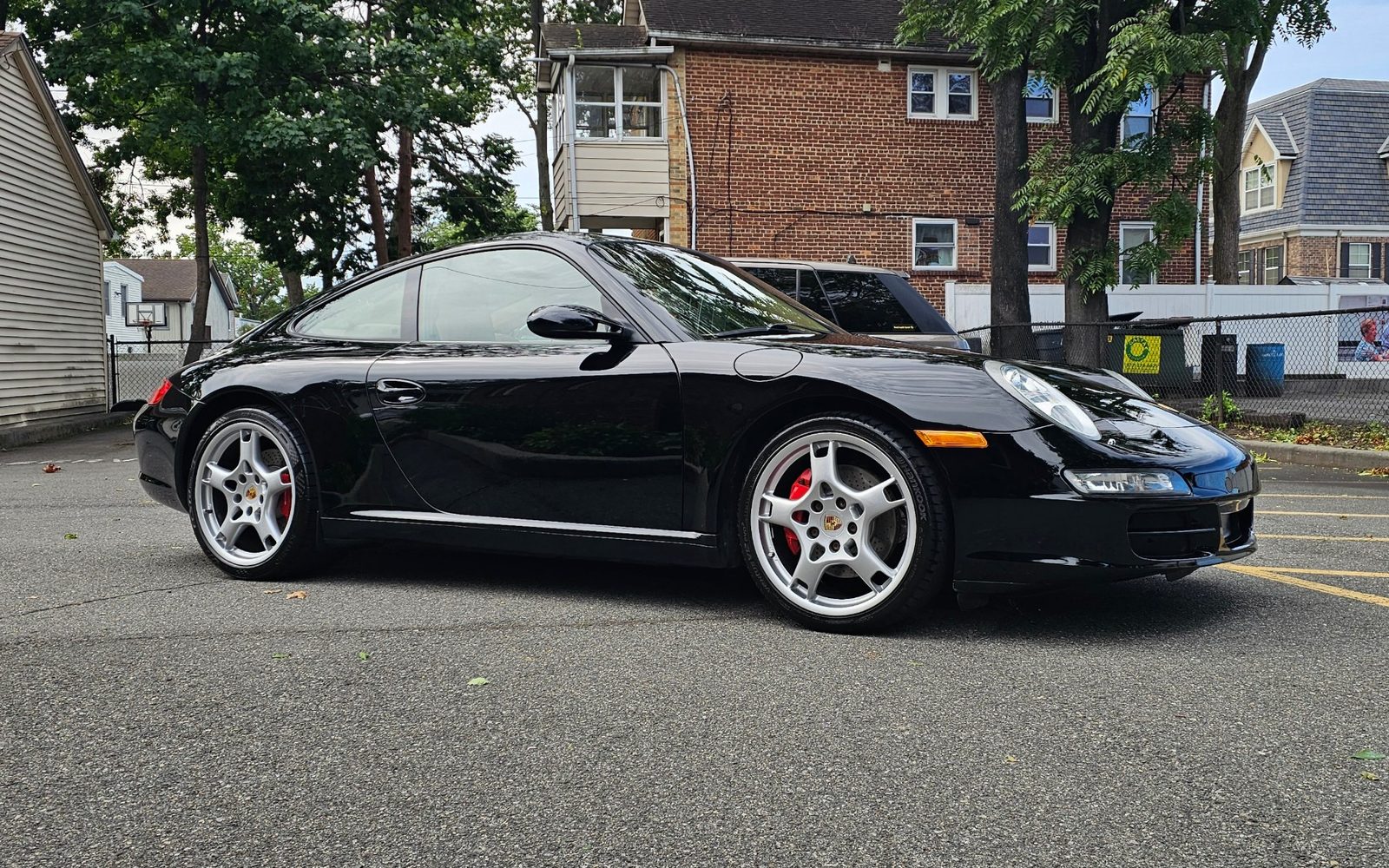 Black Porsche 911 with red brake calipers, freshly detailed